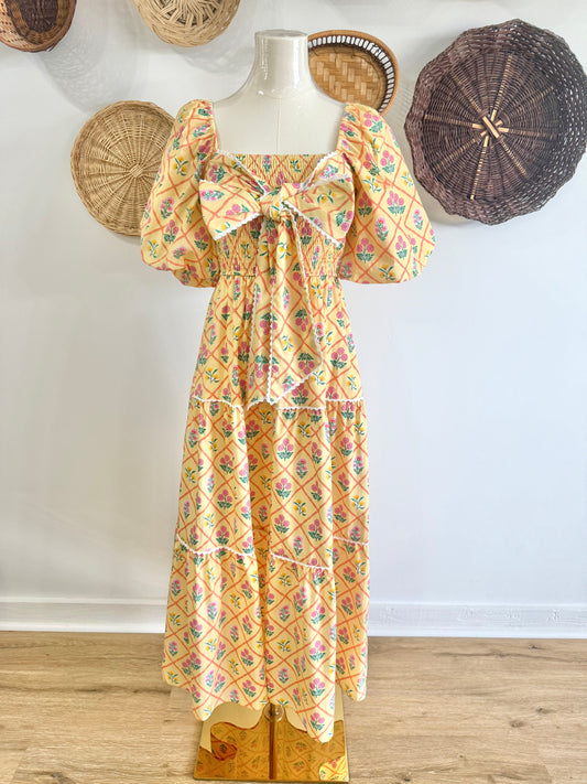The Everlynn Puff Sleeve Bow Detail Floral Maxi Dress in Yellow
