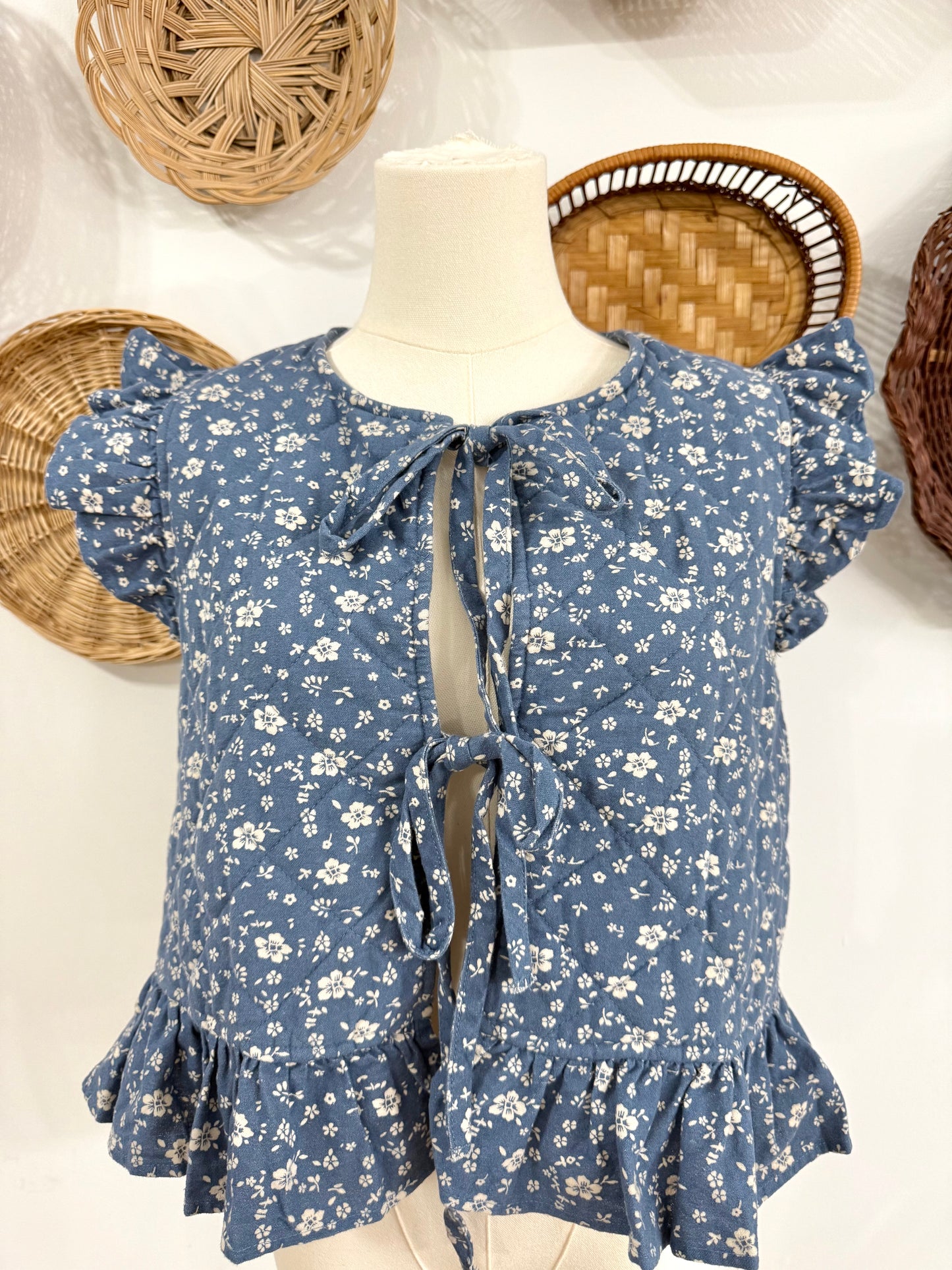 The Adora Quilted Floral Print Vest in Denim Blue