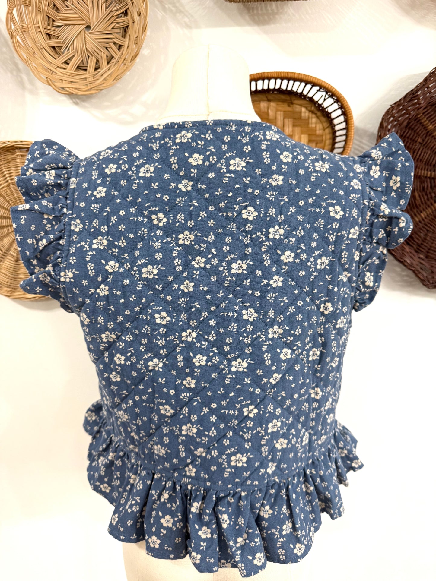 The Adora Quilted Floral Print Vest in Denim Blue